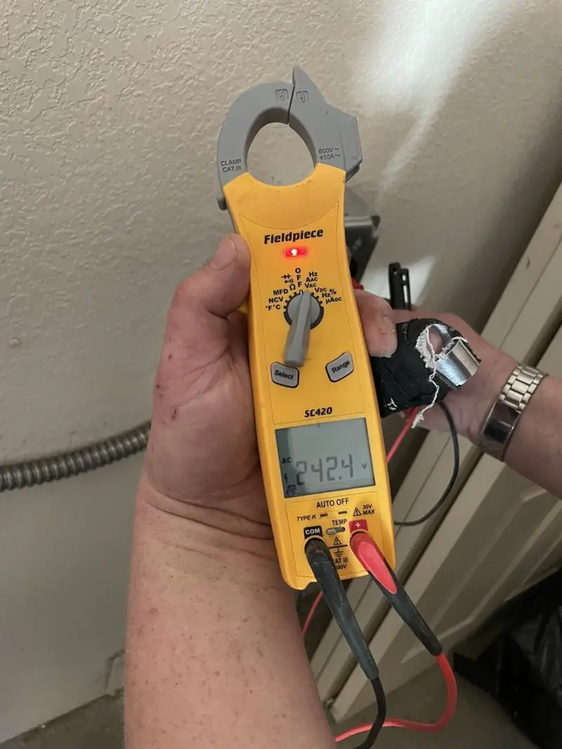 Voltage testing with clamp meter during Whole House Surge Protector in Hamilton